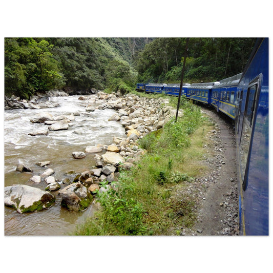 Photographie de voyage du train bleu PeruRail longeant la rivière Urubamba dans une vallée verdoyante des Andes vers le Machu Picchu - Collection Kellestom.